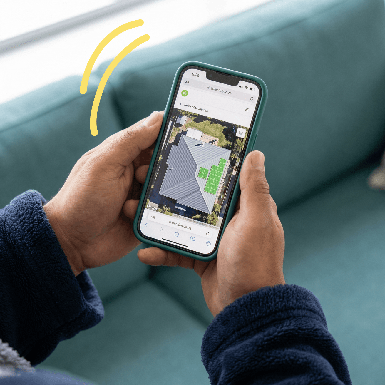 Hands holding phone showing satellite roof map with solar panel placements